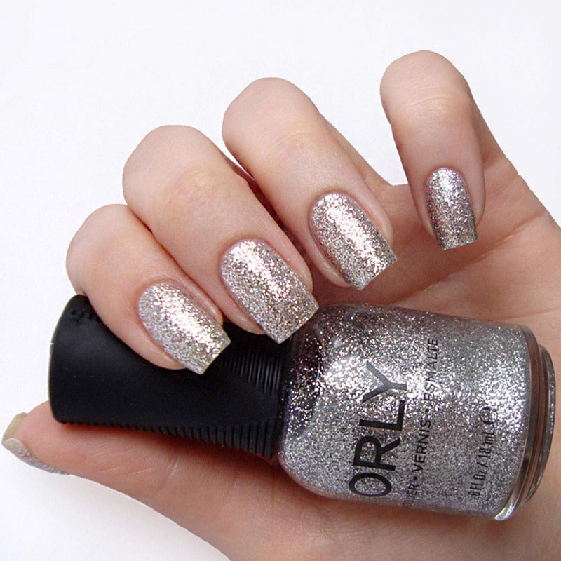 

Tiara - Nail Lacquer is a dazzling silver glitter with a sparkling shimmer finish, offering full coverage and a cool undertone.
