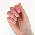 Bikini Bottoms Nail Lacquer is a vibrant starry topper featuring neon orange stars with neon pink and green dots for a playful, multi-dimensional look.