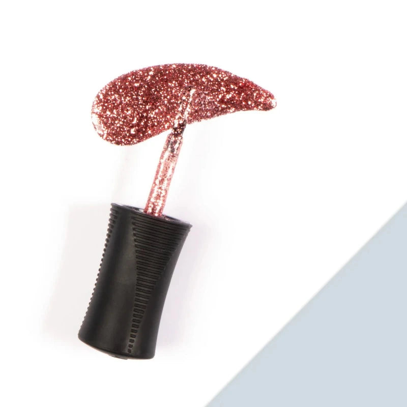 Frost Smitten Nail Lacquer is a lustrous rose gold glitter with mauve undertones, offering a dazzling, full-coverage finish that captures light beautifully.