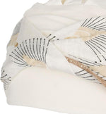 Shakti Turban Printed, Ivory w/Peacock. Its base is white, while the beautiful band features an elegant linen peacock print. It features beautiful peacock details in black and shiny gold and a fine gold trim, making it a very elegant and flattering turban.